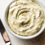 close-up of garlic herb spreadable butter in a small white bowl