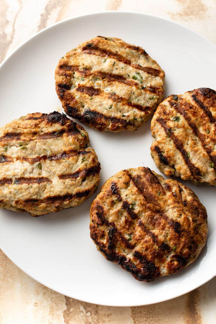 grilled ground chicken burger patties (cooked) on a plate