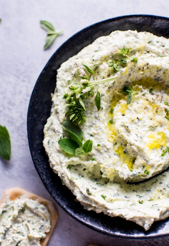 close-up of whipped herb feta spread in a bowl