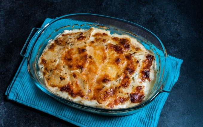 glass baking dish with lemon and oregano potato gratin