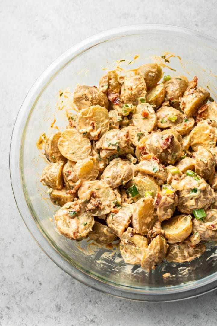 potato salad with bacon in a glass prep bowl (tossed)