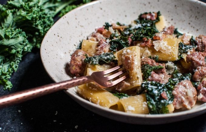 bowl with one-pot rigatoni with sausage, bacon, and kale