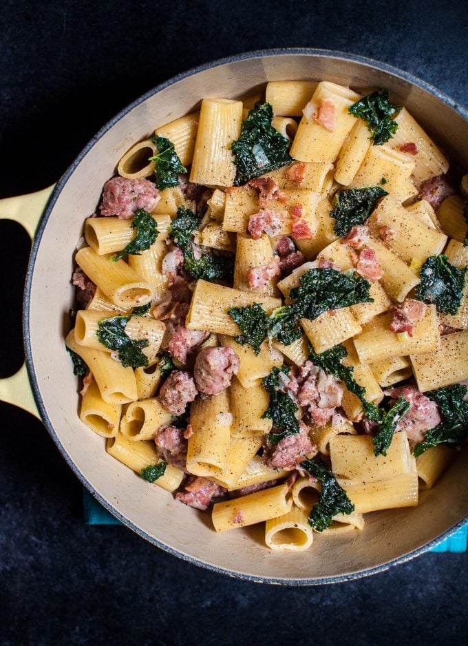 yellow pot with rigatoni with sausage, bacon, and kale