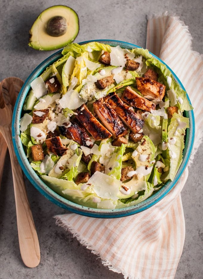 BBQ chicken garlic Caesar salad in a large blue serving bowl