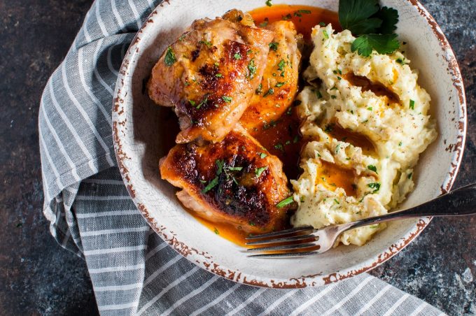 close-up of crispy braised apricot chicken with mashed potatoes