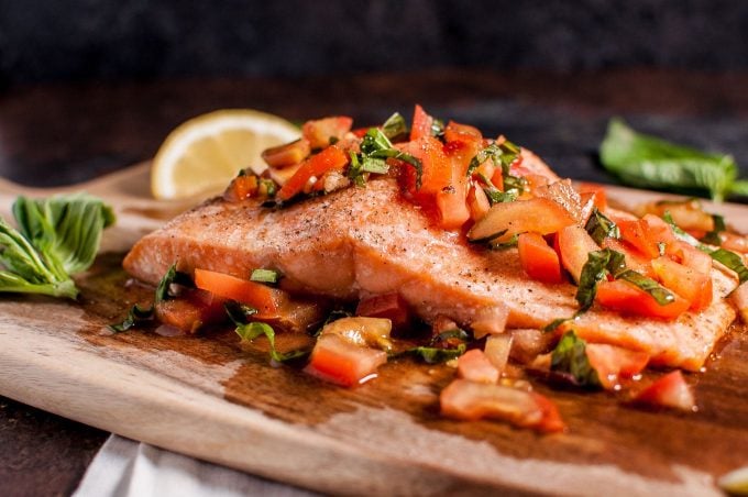 close-up of easy bruschetta salmon on a wooden cutting board