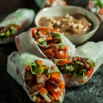 Sticky-sweet caramelized pork is complemented by crisp lettuce, carrots, and cucumber and wrapped in rice paper with vermicelli. The creamy peanut sauce makes the perfect dip for these fresh summer rolls.