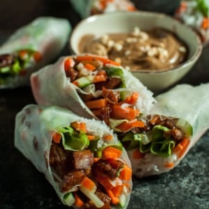 Sticky-sweet caramelized pork is complemented by crisp lettuce, carrots, and cucumber and wrapped in rice paper with vermicelli. The creamy peanut sauce makes the perfect dip for these fresh summer rolls.
