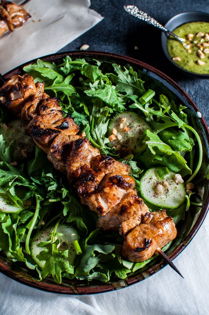 close-up of chicken kabob salad in a bowl with peanut lime dressing