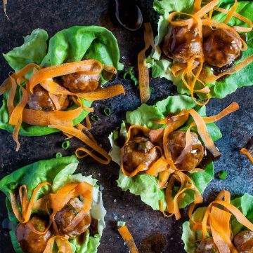 Tender, flavorful pork meatballs are coated in an easy and delicious homemade teriyaki sauce. Ribbons of carrot and butter leaf lettuce cups add some color and crunch to this lightened up meal.