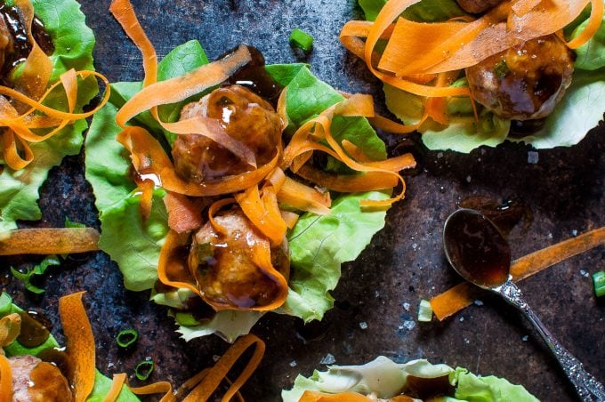 close-up of a homemade teriyaki meatball lettuce wrap with carrots