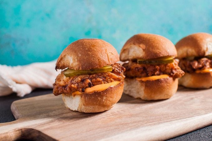 tender fried chicken sliders with spicy mayo on a cutting board