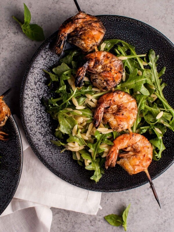 Smoky grilled shrimp, orzo, and fresh arugula tossed with a garlicky lemon dressing makes a delicious light meal or appetizer.