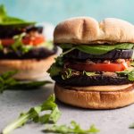 Devour these delicious veggie burgers with grilled portobello mushrooms and eggplant! Fried shallots, more fresh veggies, and a smoky mayo make this a healthier way to get your burger fix.