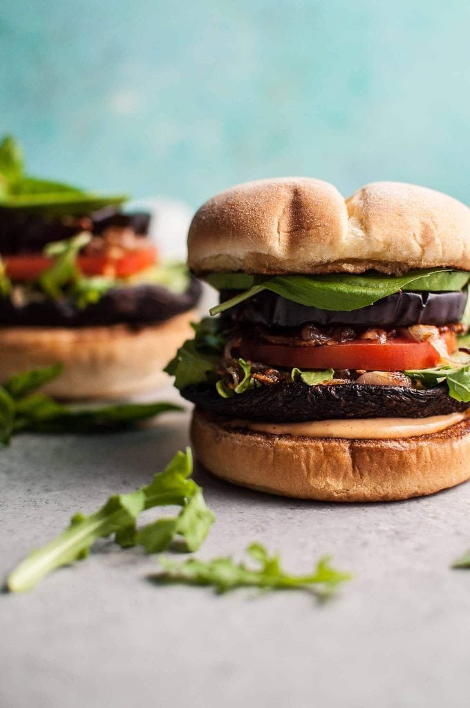 close-up of a grilled portobello mushroom burger with eggplant and smoky mayo