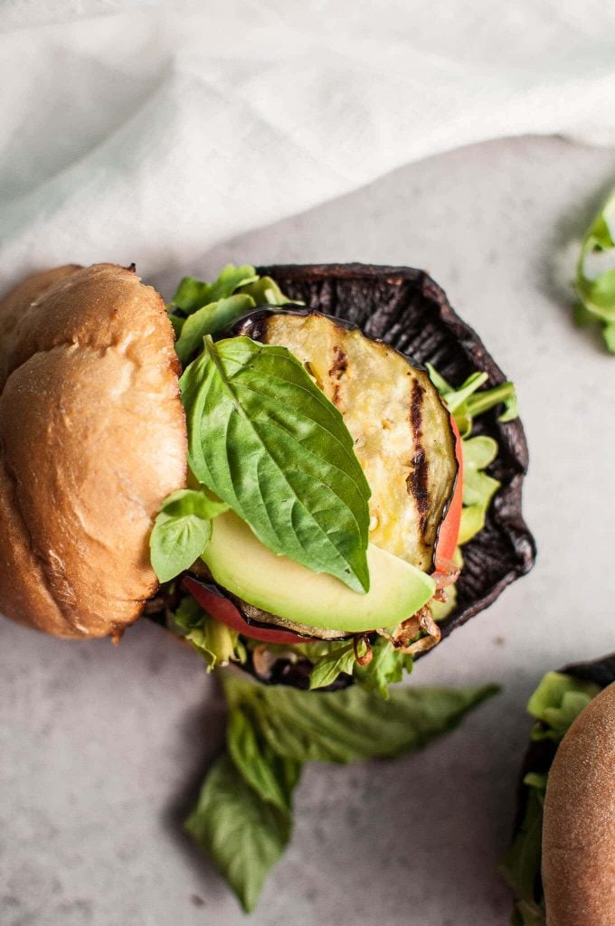 close-up of portobello mushroom burger showing slice of grilled eggplant