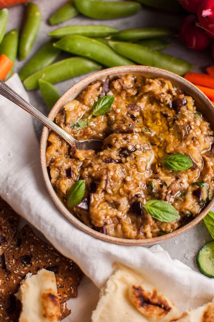 close-up of healthy eggplant dip in a bowl with a spoon