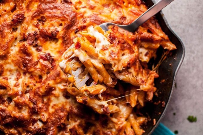 close-up of bacon cheese baked skillet penne on a serving spatula