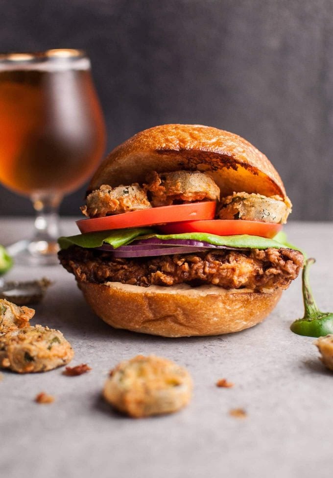 close-up of southwest fried chicken sandwich with lettuce, tomato, and fried jalapenos