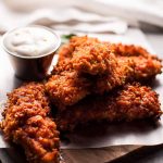 Sriracha honey chicken tenders are crunchy, spicy, sweet, and sticky. Served with a refreshing dipping sauce on the side!