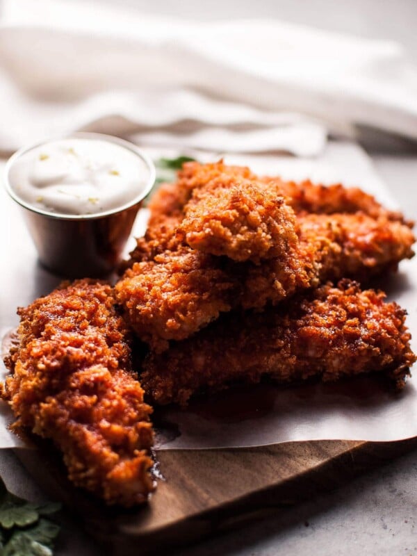 Sriracha honey chicken tenders are crunchy, spicy, sweet, and sticky. Served with a refreshing dipping sauce on the side!