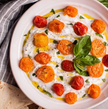 This summer Greek yogurt dip with roasted little tomatoes and fresh herbs makes a wonderful appetizer or snack! It's healthy, filling, and delicious.