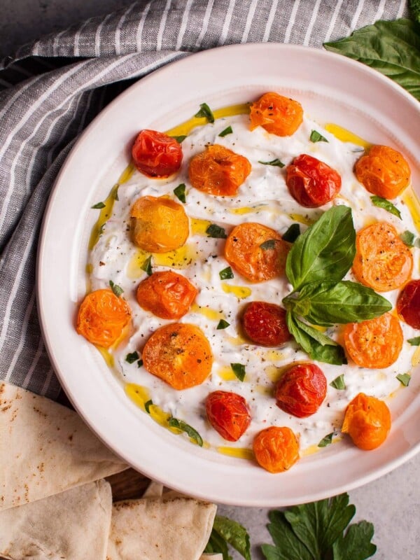 This summer Greek yogurt dip with roasted little tomatoes and fresh herbs makes a wonderful appetizer or snack! It's healthy, filling, and delicious.