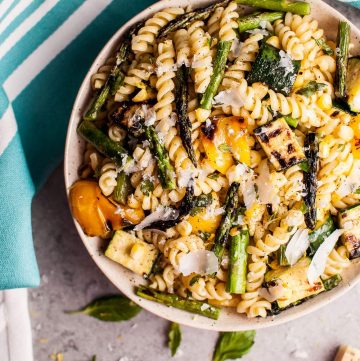 This grilled summer vegetable pasta salad is healthy and full of flavor! Zucchini, asparagus, corn, and yellow bell peppers are grilled to perfection and tossed with a fresh, lemony dressing. Easy to make and feeds a crowd!