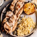 Juicy and flavorful rosemary chicken skewers are perfectly complemented with charred lemon and a delicious garlicky yogurt. Serve with orzo and naan, and you've got a fab feast on your hands.