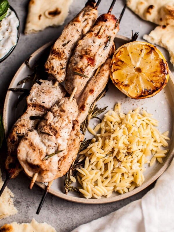 Juicy and flavorful rosemary chicken skewers are perfectly complemented with charred lemon and a delicious garlicky yogurt. Serve with orzo and naan, and you've got a fab feast on your hands.