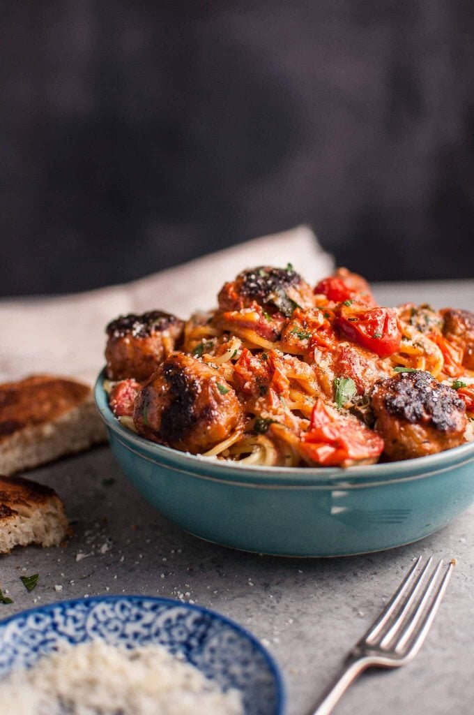 blue bowl of sausage meatballs with spaghetti