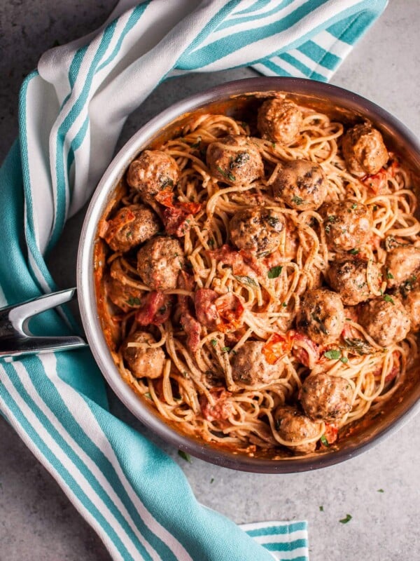 This sausage meatball spaghetti with roasted tomatoes is bursting with fresh flavor! Basil, cream, and plenty of garlic make this pasta dish a winner.