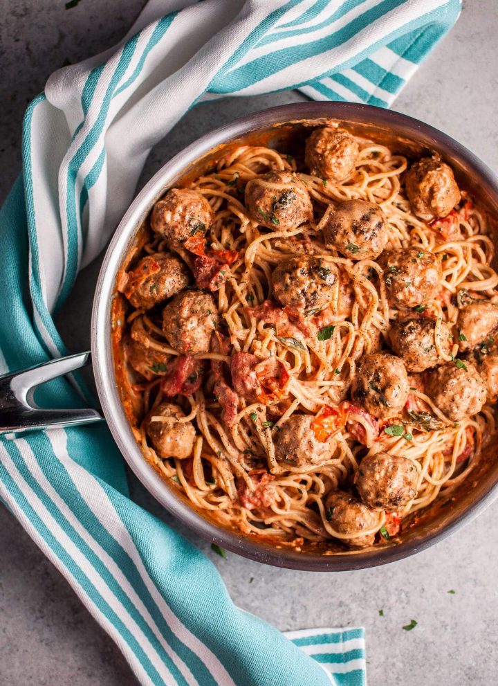 This sausage meatball spaghetti with roasted tomatoes is bursting with fresh flavor! Basil, cream, and plenty of garlic make this pasta dish a winner.