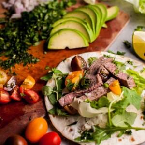 Summer steak tacos are easy, healthy, and full of flavor! Fresh oregano, parsley, cilantro, lime, and arugula kick up the taste in this 20 minute meal.