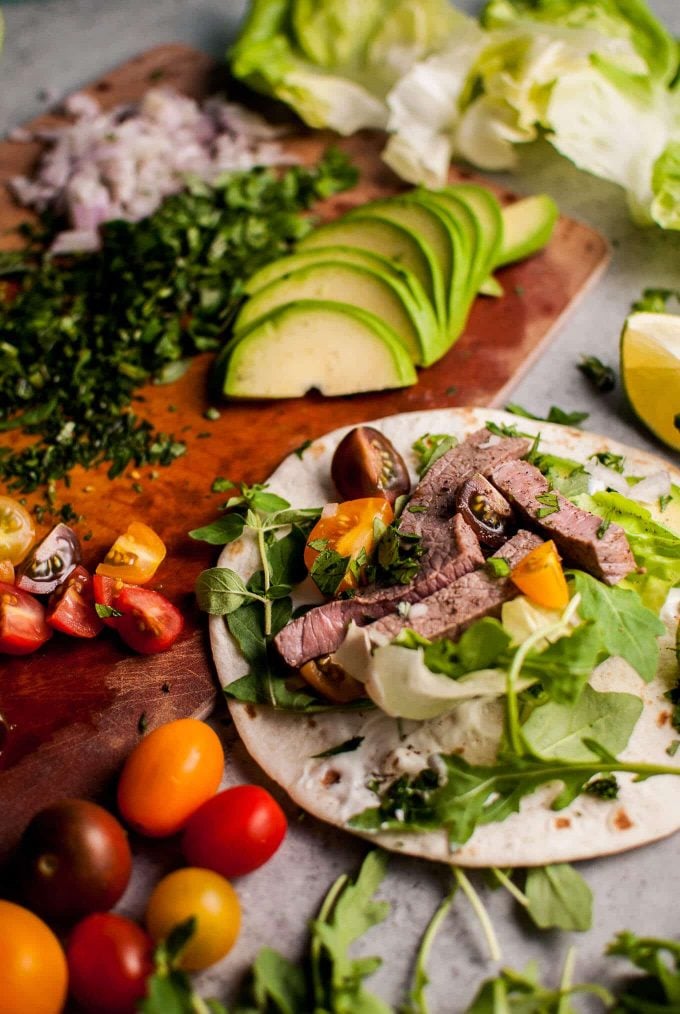 close-up of a summer steak taco with tomatoes and avocado slices