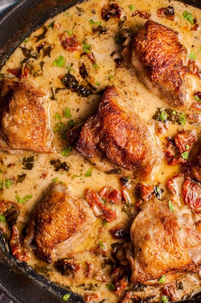 close-up of crispy chicken in a creamy sun-dried tomato and basil sauce