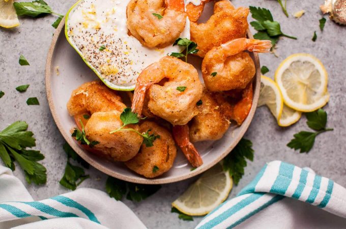 plate of beer battered crisp shrimp with mayo dip on an appetizer plate