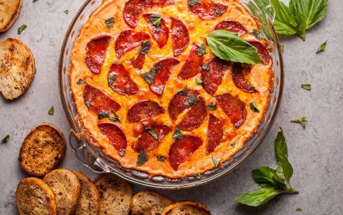 cheesy chorizo pizza dip in glass dish