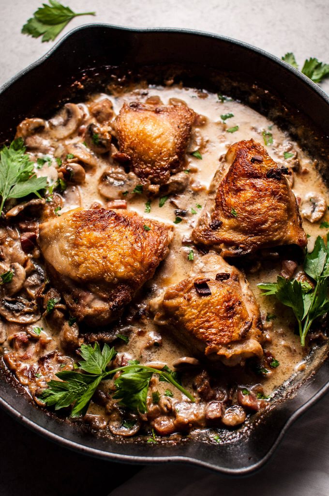 close-up of creamy bourbon chicken with mushrooms and pancetta