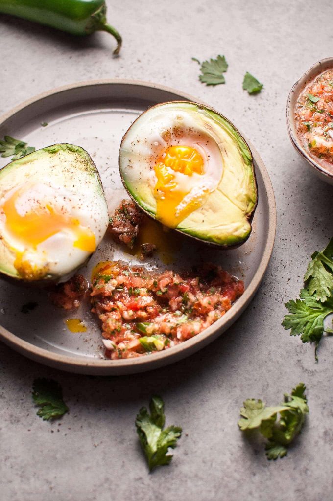 two keto huevos rancheros avocado halves on a plate