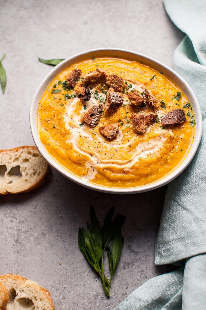 close-up of bowl of healthy pumpkin and cauliflower soup with ginger