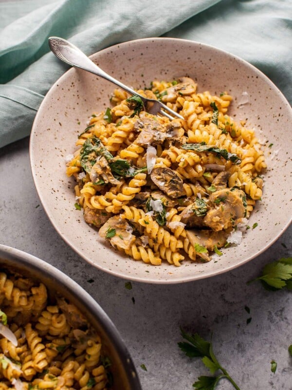 Pumpkin, mushroom, and spinach pasta is a healthy, comforting, and filling vegetarian fall dish.