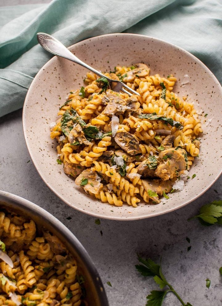 Pumpkin, mushroom, and spinach pasta is a healthy, comforting, and filling vegetarian fall dish.