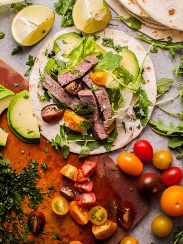 Summer steak tacos are easy, healthy, and full of flavor! Fresh oregano, parsley, cilantro, lime, and arugula kick up the taste in this 20 minute meal.