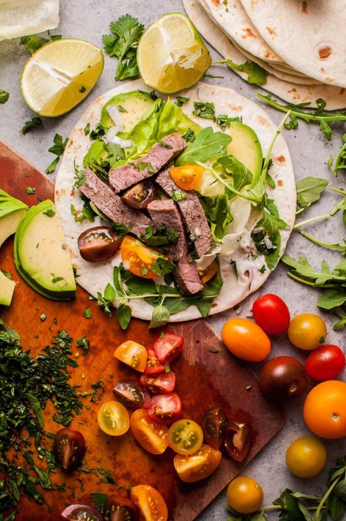 summer steak taco beside vegetables on a cutting board