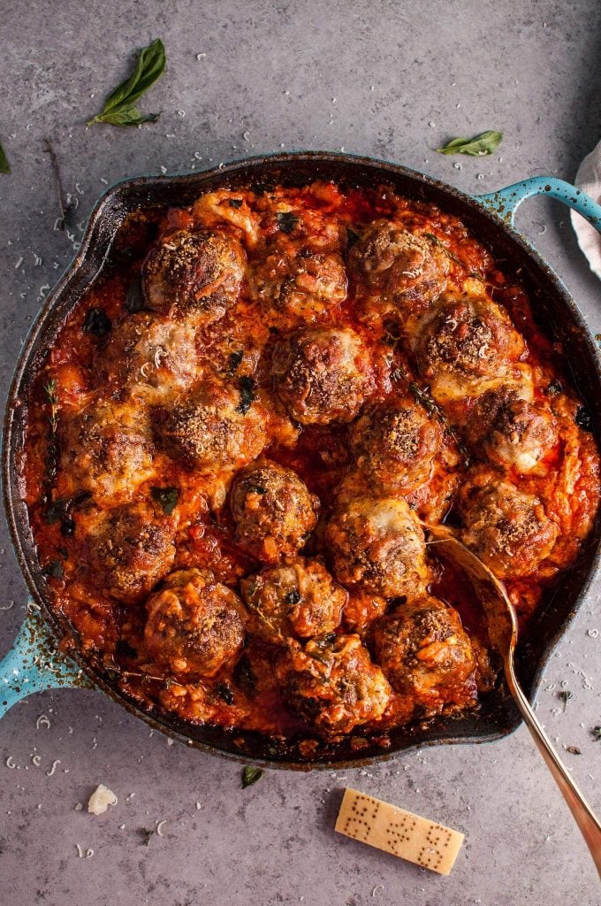 cheesy baked meatballs in a cast iron skillet