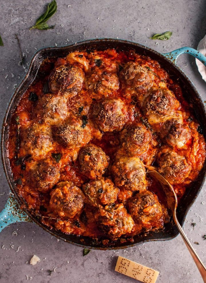 Hello cheesy baked meatball skillet of your dreams! Tender and flavorful meatballs, a rich tomato sauce, and plenty of melted cheese make this skillet recipe a winner.