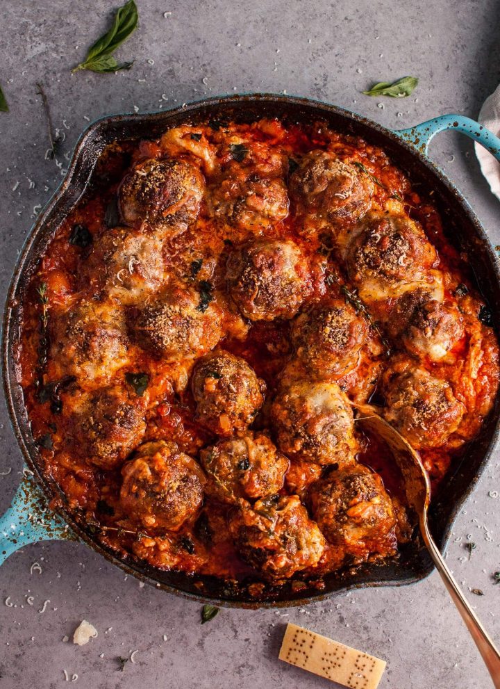 Hello cheesy baked meatball skillet of your dreams! Tender and flavorful meatballs, a rich tomato sauce, and plenty of melted cheese make this skillet recipe a winner.