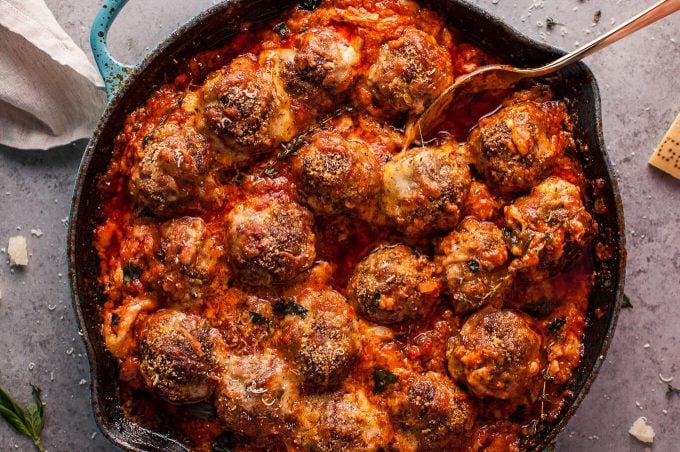 cheesy baked meatball skillet with serving spoon