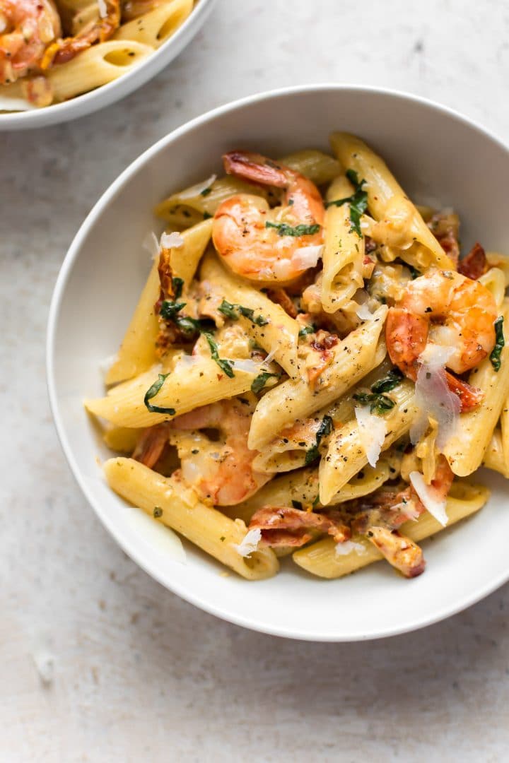 creamy Cajun shrimp penne in a white bowl